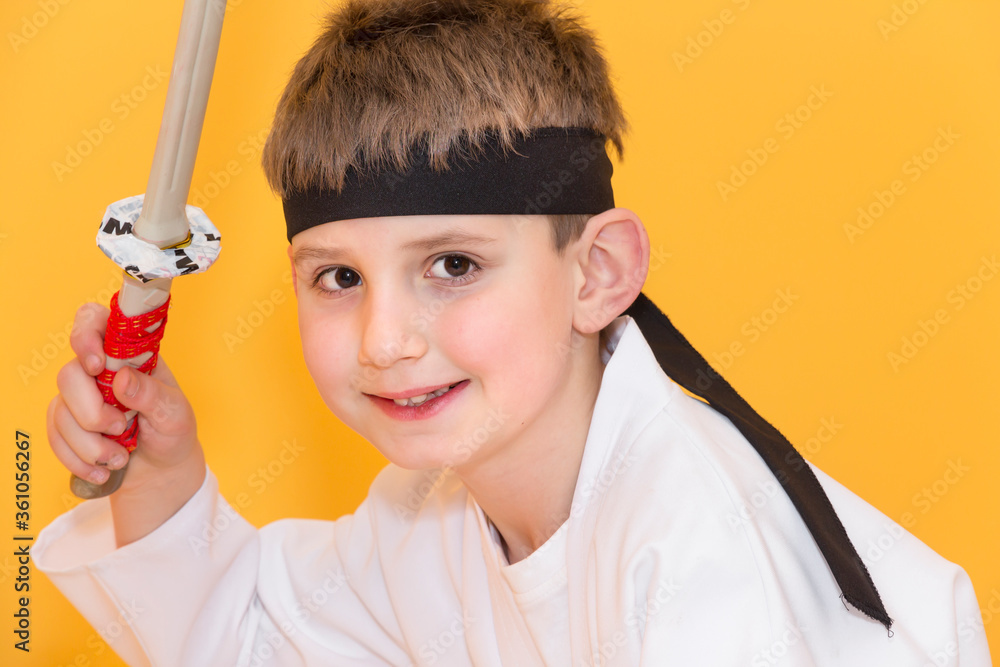 Little boy as a karate fighter. Funny faces.