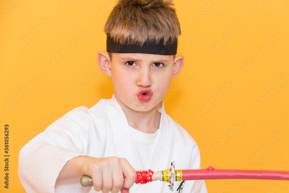 Little boy as a karate fighter. Funny faces.