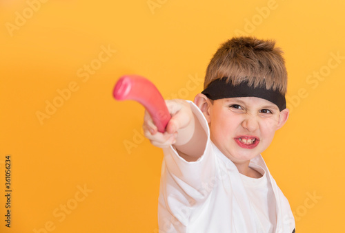 Obraz na płótnie Little boy as a karate fighter. Funny faces. w salonie
