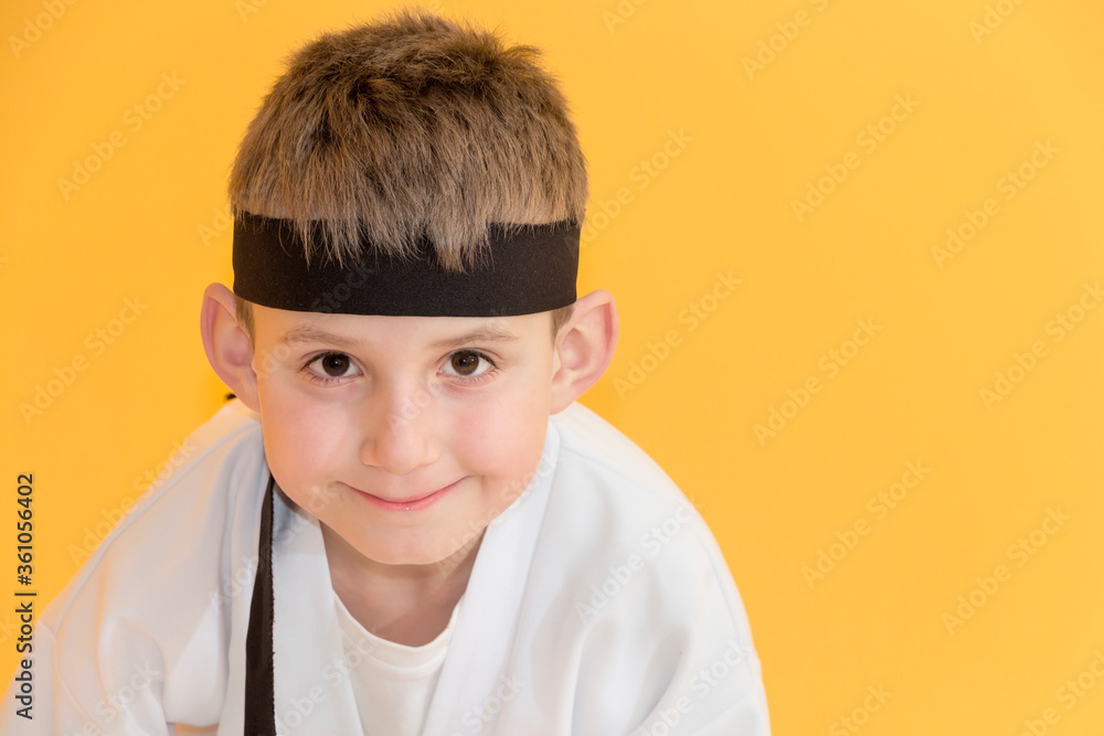 Little boy as a karate fighter. Funny faces.