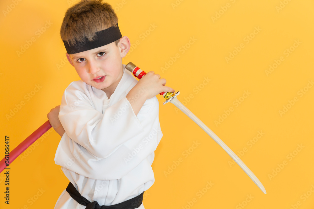 Little boy as a karate fighter. Funny faces.