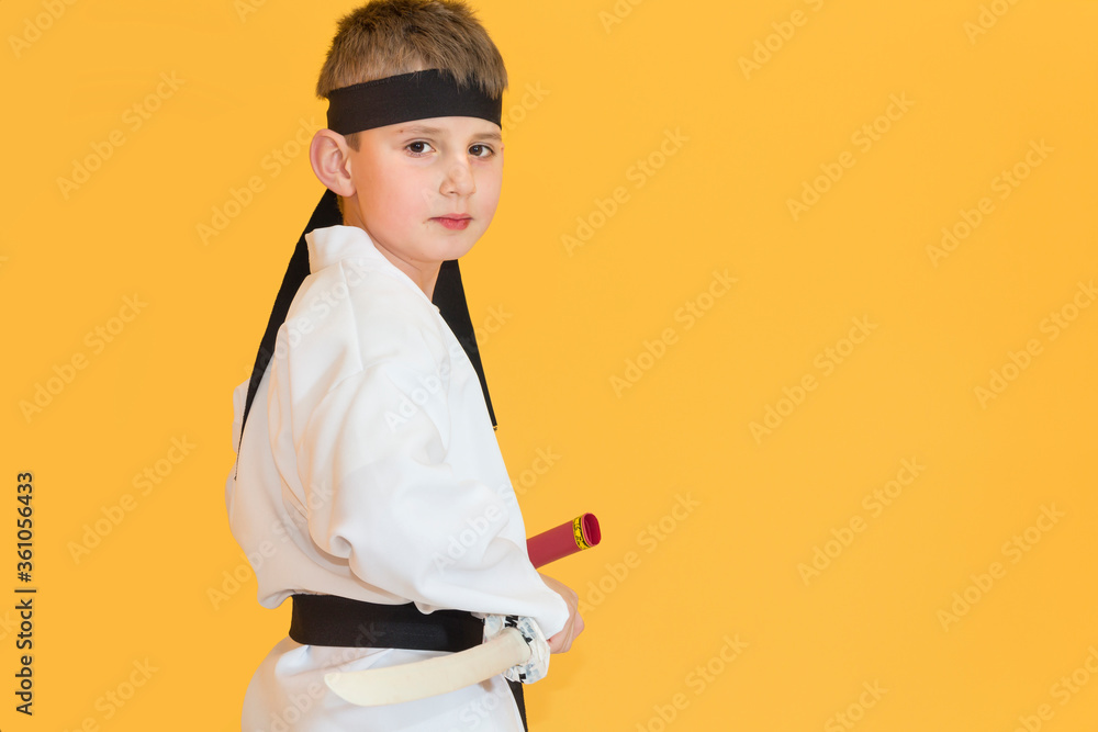 Little boy as a karate fighter. Funny faces.