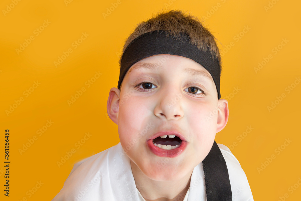 Little boy as a karate fighter. Funny faces.