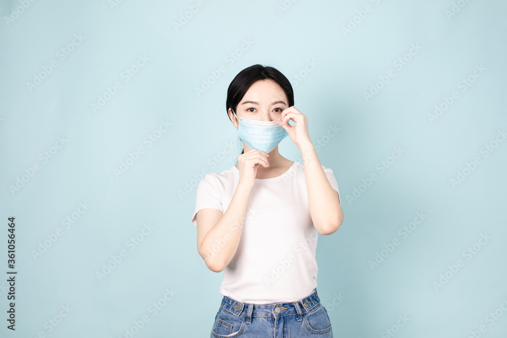 A Young Chinese Woman In Front of Blue Background A Young Chinese Woman In Front of Blue Background
