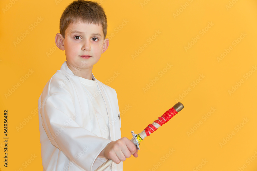Little boy as a karate fighter. Funny faces.