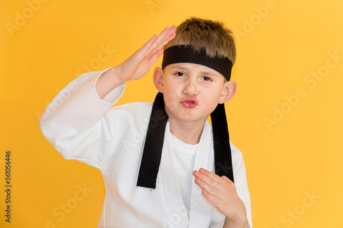 Obraz na płótnie Little boy as a karate fighter. Funny faces. w salonie
