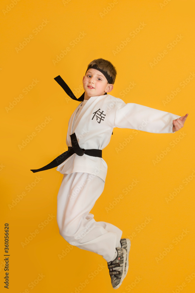 Little boy as a karate fighter. Funny faces.
