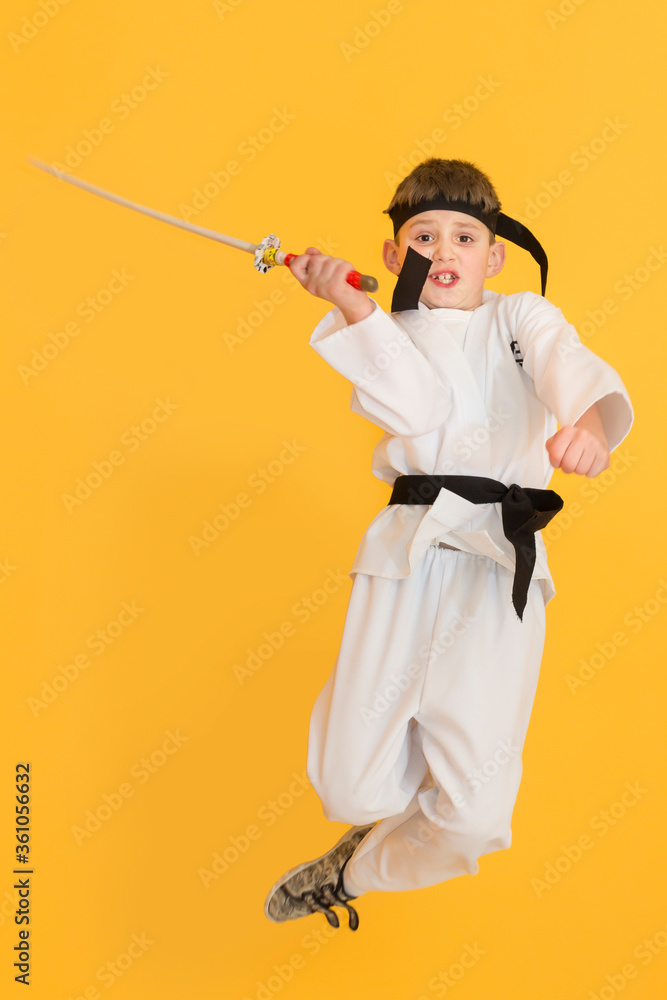 Little boy as a karate fighter. Funny faces.