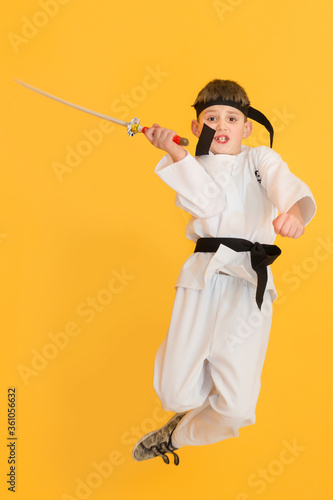 Obraz na płótnie Little boy as a karate fighter. Funny faces. w salonie