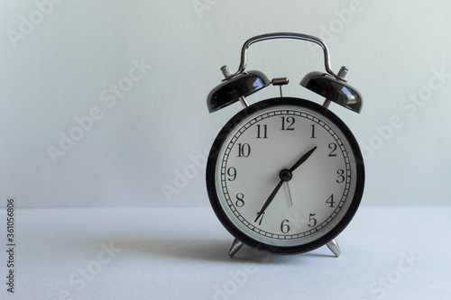 clock with alarm clock on white background with place for inscription. time management, business investment, planning