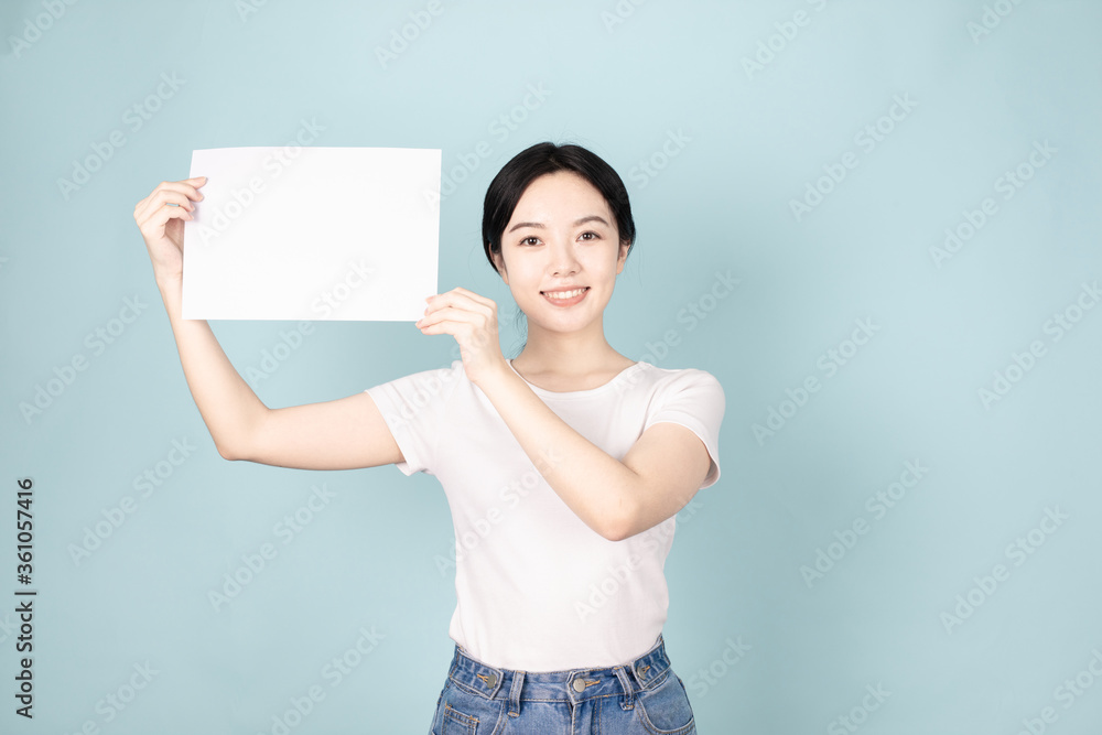 A Young Chinese Woman In Front of Blue Background A Young Chinese Woman In Front of Blue Background