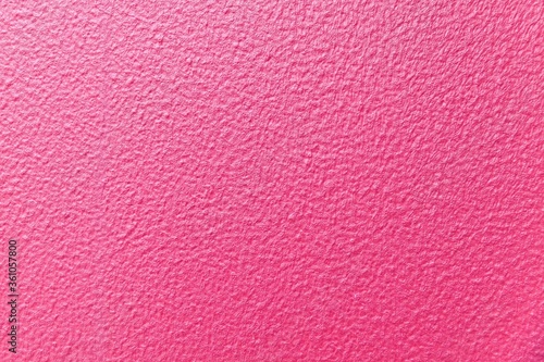 Cement wall patterned with pink color texture and seamless background