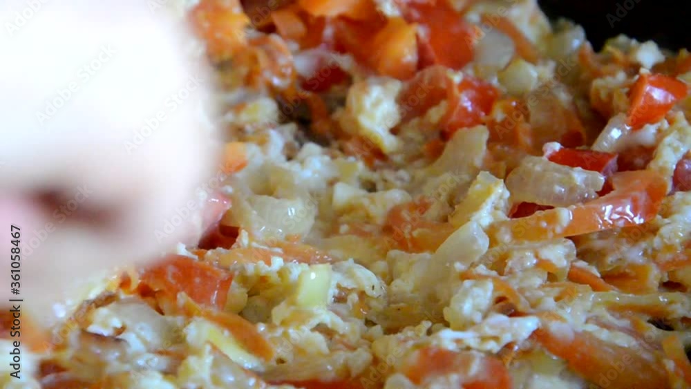 breakfast with scrambled Eggs Girl fries eggs in a pan with vegetables, omelette, fried eggs breakfast with scrambled Eggs Girl fries eggs in a pan with vegetables, omelette, fried eggs