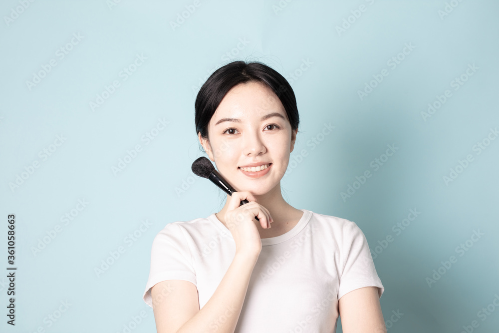 A Young Chinese Woman In Front of Blue Background A Young Chinese Woman In Front of Blue Background