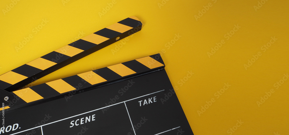 Clapper board or movie slate. it use in video production and cinema industry on yellow background.