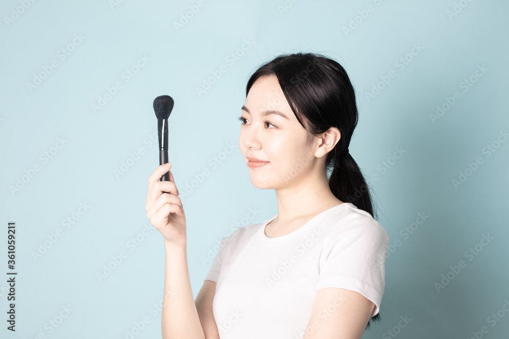 A Young Chinese Woman In Front of Blue Background A Young Chinese Woman In Front of Blue Background