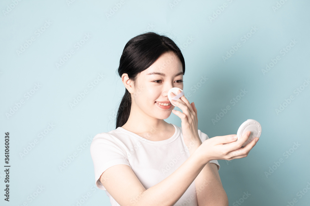 A Young Chinese Woman In Front of Blue Background A Young Chinese Woman In Front of Blue Background