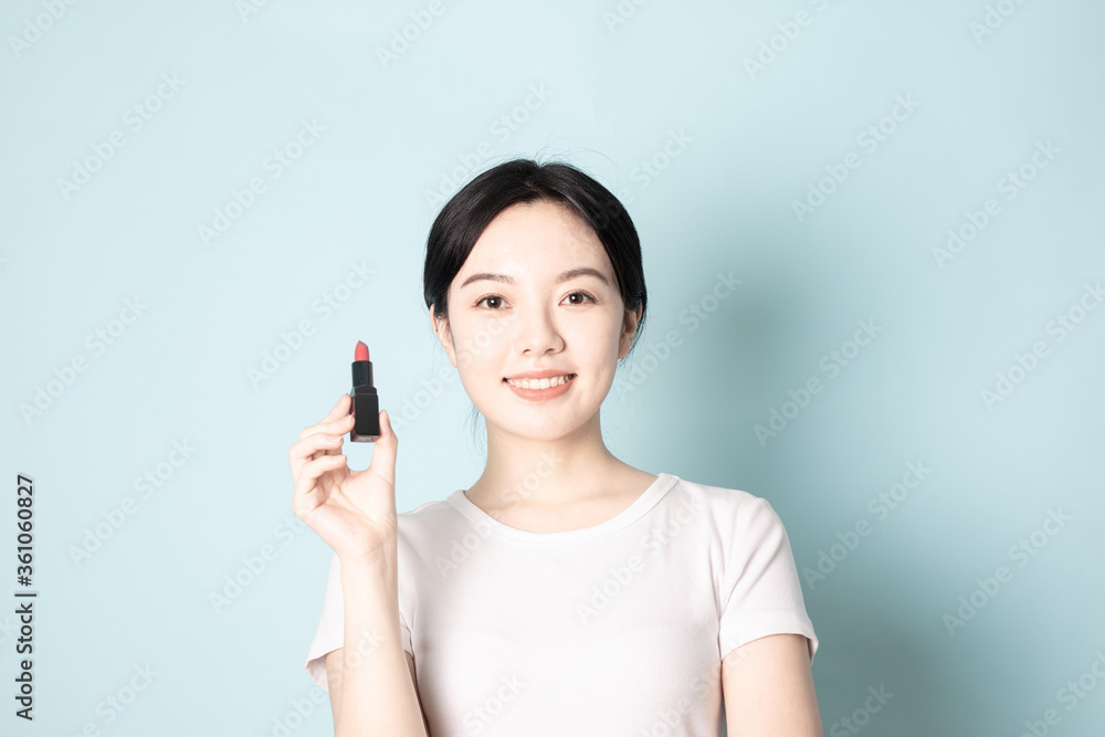 A Young Chinese woman in front of a blue background A Young Chinese woman in front of a blue background