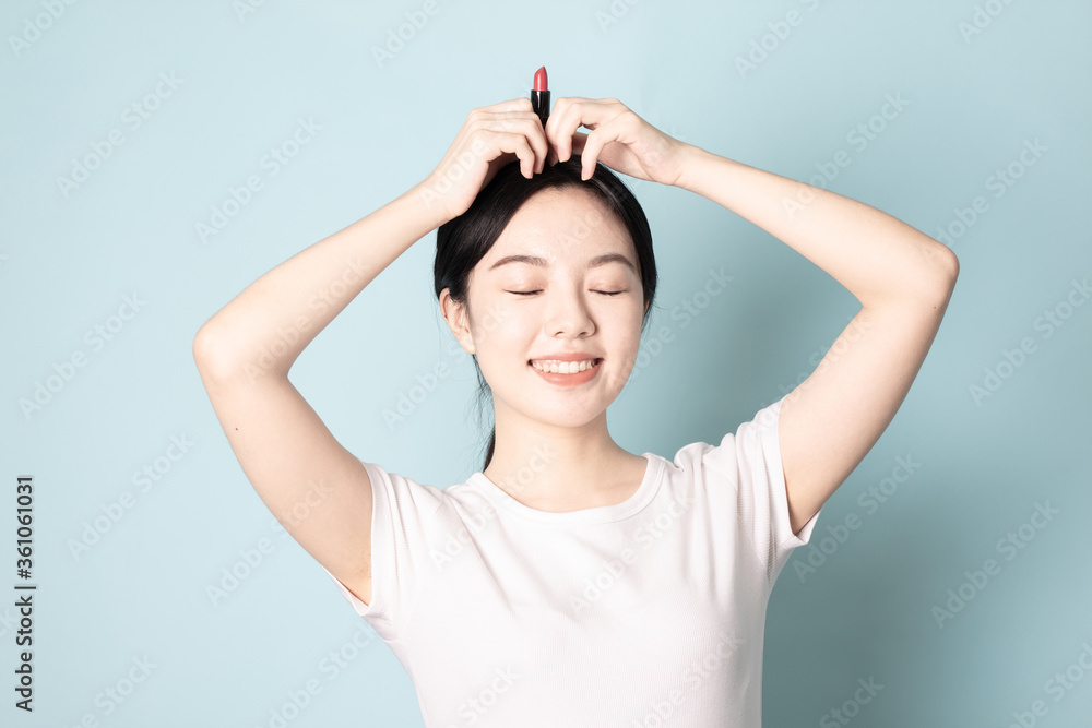 Fototapeta premium A Young Chinese woman in front of a blue background