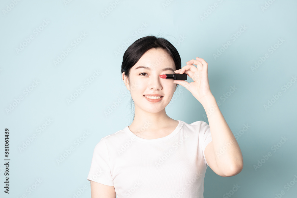 A Young Chinese woman in front of a blue background A Young Chinese woman in front of a blue background