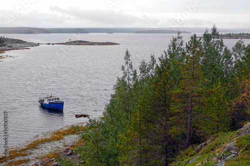 Karelian landscape. Motor boat by Sidorov island. Kandalaksha Gulf of White Sea. Republic of Karelia, Russia. photo