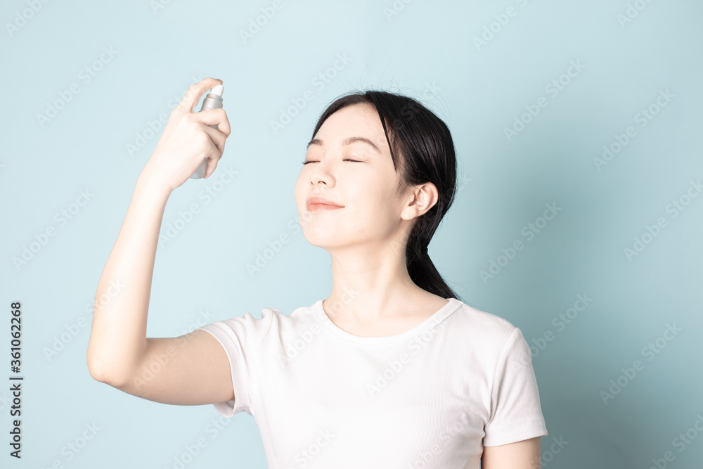 A Young Chinese woman in front of a blue background A Young Chinese woman in front of a blue background