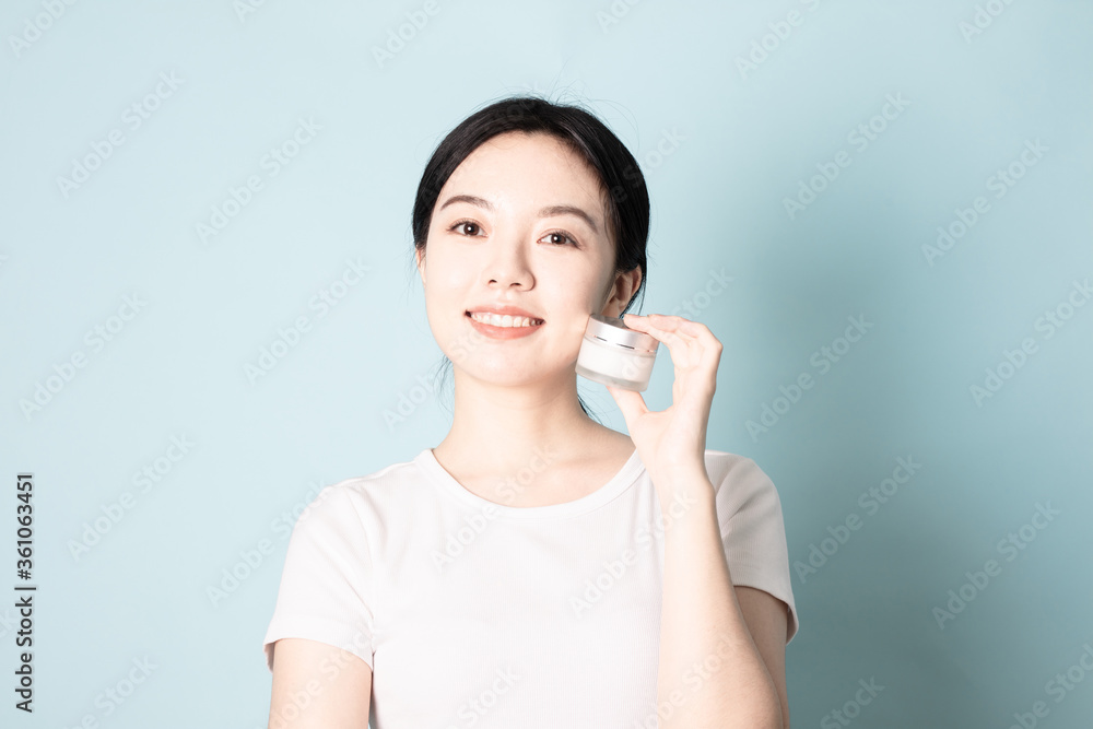 A Young Chinese woman in front of a blue background A Young Chinese woman in front of a blue background