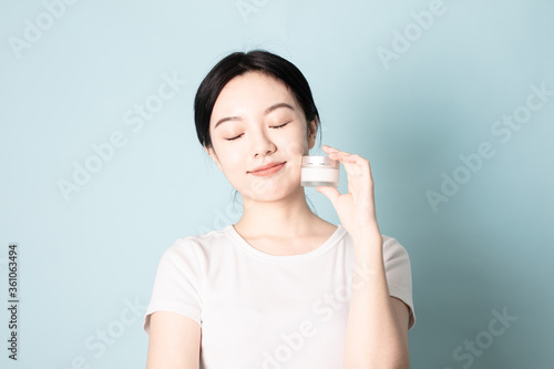 A Young Chinese woman in front of a blue background