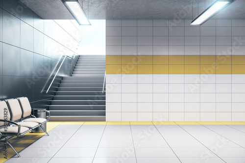 Chairs for waiting in modern metro station with blank wall. photo