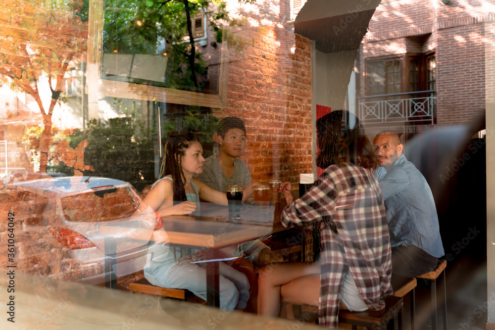 A group of friends together in a bar A group of friends together in a bar