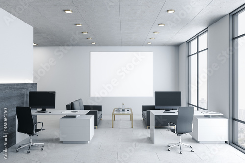 Coworking office interior with blank billboard on wal