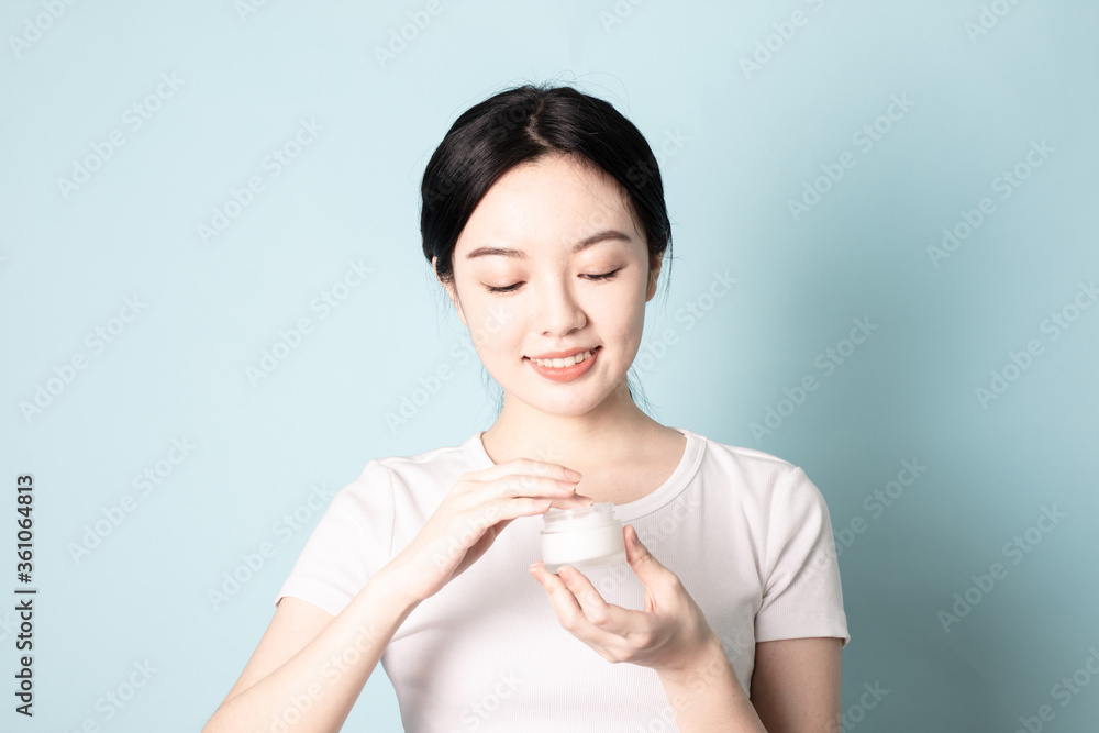 A Young Chinese woman in front of a blue background A Young Chinese woman in front of a blue background