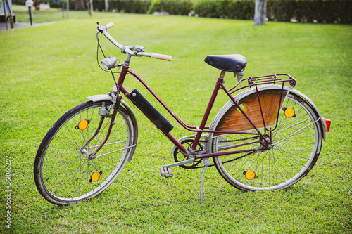 Old vintage bicycle on grass on summer background