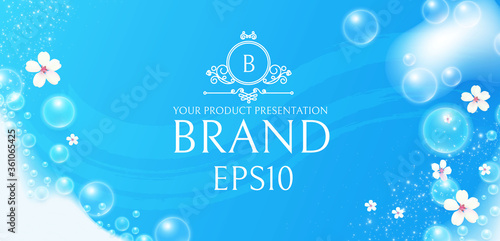 Soap foam with flowers on blue background. White transparent lather with bubbles. Fresh and clean product adverticing.
