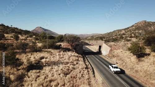 4K aerial drone video of African savanna hills, railway bridge over B1 highway south of Windhoek in central highland Khomas Hochland of Namibia, southern Africa photo