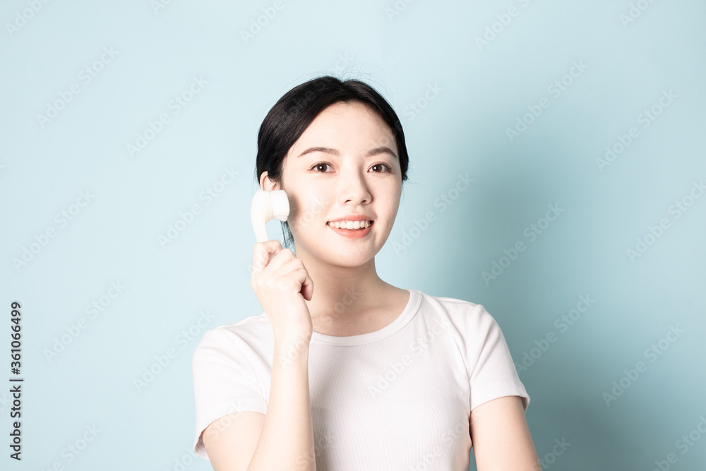 A Young Chinese woman in front of a blue background