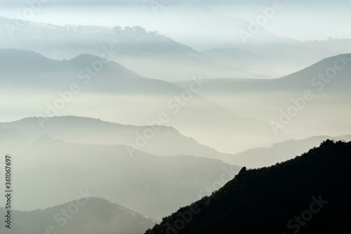 Misty mountains hills and c...