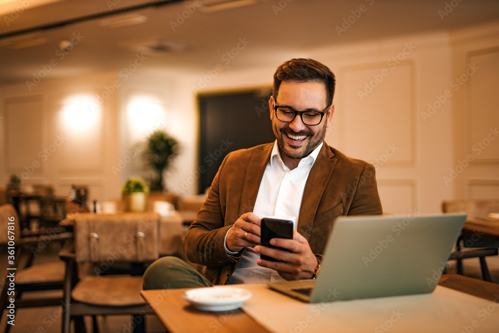 Portrait of a positive entrepreneur at the cafe, using smart phone and laptop. Portrait of a positive entrepreneur at the cafe, using smart phone and laptop.