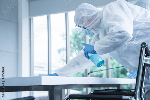 Specialist team in virus protective suite and mask spraying alcohol and cleaning covid19 infected area, Virus disinfection concept