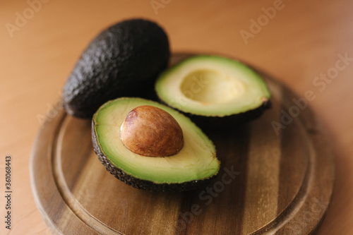 Fresh sliced avocado on wooden board. Vegetarian food concept