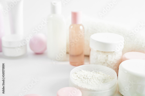 Flat lay composition Natural cosmetics ingredients for skincare  body and hair care.Top view bottles with facial treatment product white background. Makeup Layout. Set of traditional spa products.