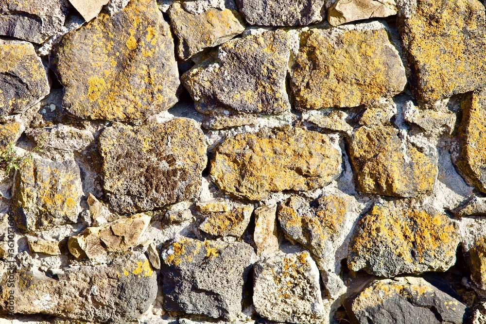 Ancient stone wall close up view. Old stonework Texture. Natural antique stone wall pattern. Construction industry raw materials. Natural Building materials. Vintage stone walls. Abstract backgrounds. Ancient stone wall close up view. Old stonework Texture. Natural antique stone wall pattern. Construction industry raw materials. Natural Building materials. Vintage stone walls. Abstract backgrounds.