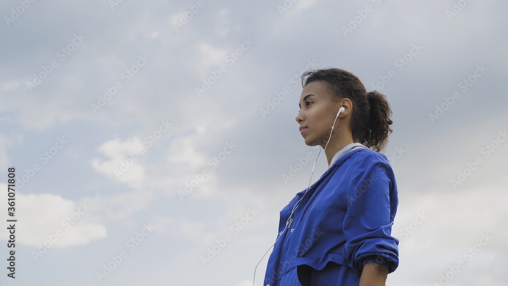 Afro-american runner woman resting exhausted after intense running workout training cardio athletic female sportswoman in city Afro-american runner woman resting exhausted after intense running workout training cardio athletic female sportswoman in city