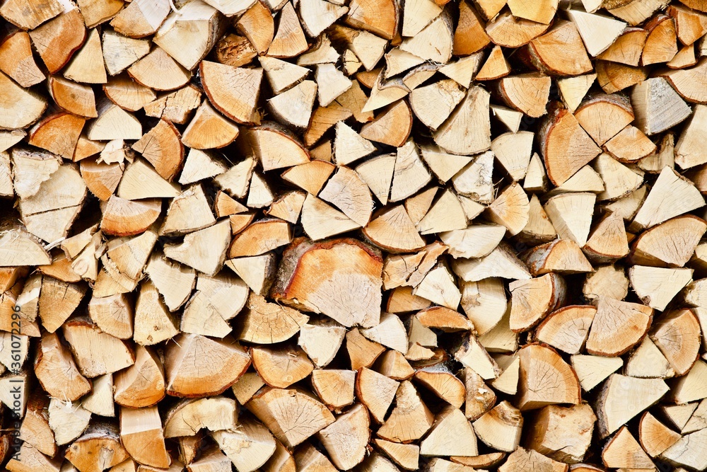 Stacked firewood close-up. Firewood storage close up. Stocks of wooden logs close-up. Chopping wood. Logging in the village. Rustic lifestyle. Woodpile with firewood full frame image. Wooden texture. Stacked firewood close-up. Firewood storage close up. Stocks of wooden logs close-up. Chopping wood. Logging in the village. Rustic lifestyle. Woodpile with firewood full frame image. Wooden texture.