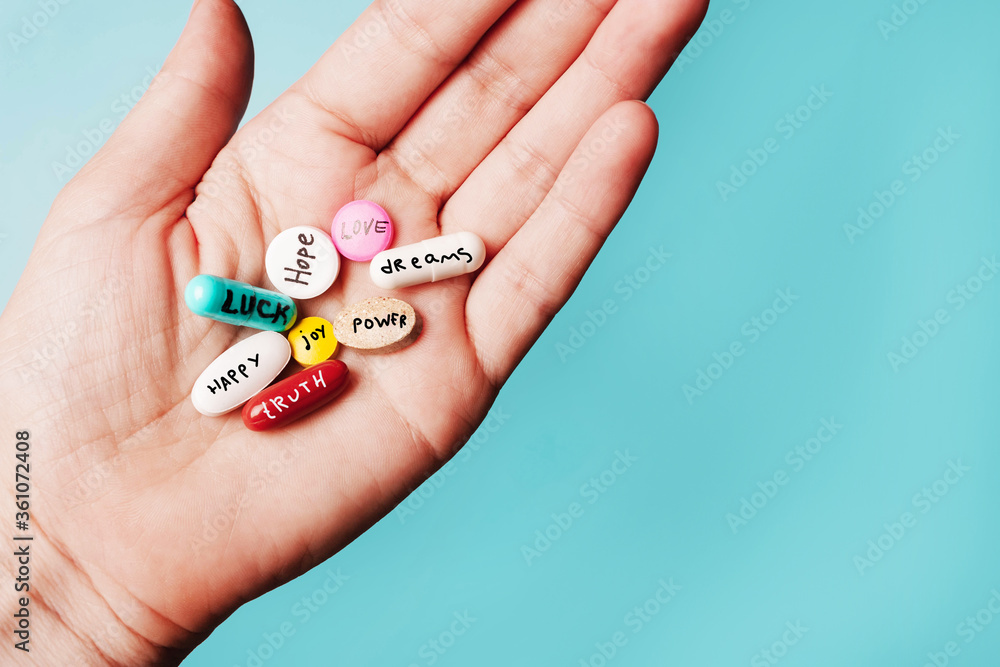 concept of creative pills, a placebo in the hand, with joy, love, happiness, truth, power, dream concept of creative pills, a placebo in the hand, with joy, love, happiness, truth, power, dream