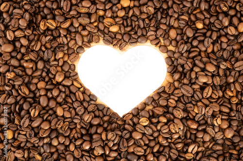 Heart formed by coffee beans on wood