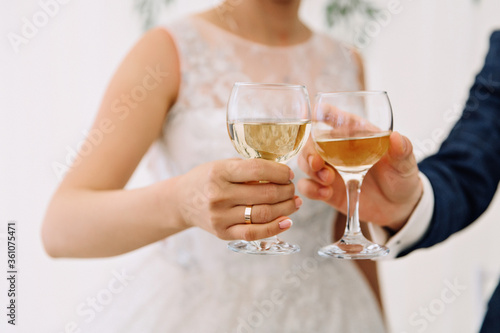 bride and groom holding champagne glasses
