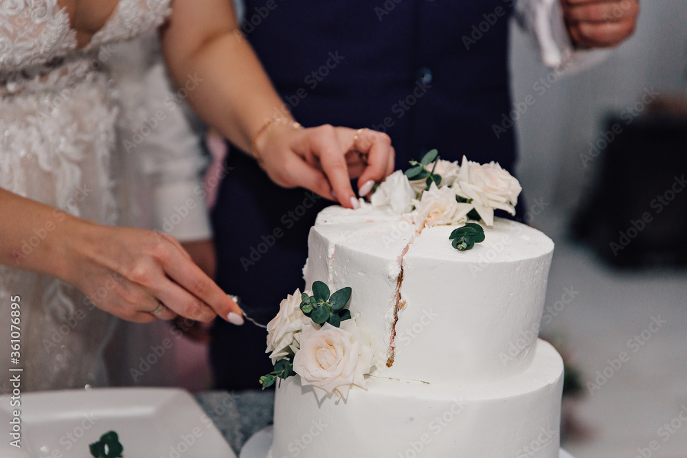 bride and groom holding wedding cake bride and groom holding wedding cake