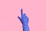 Isolated female hand in a blue medical glove, touching or pointing to something.