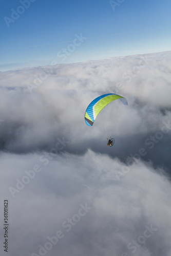 Paraglider above the clouds